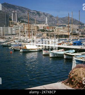 1960s, historical, small sailing boats moored in Port Hercules, Monaco, with the luxury apartment blocks in the distance. In use since ancient times and the only deep-water port in the principality, the modernisation of the port was completed in 1926. Stock Photo