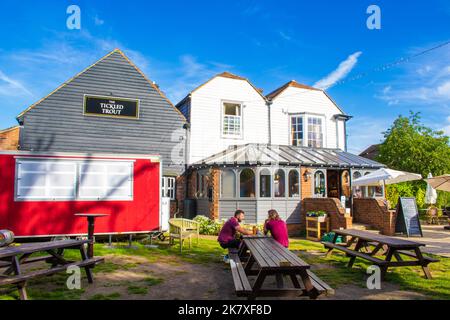 The Tickled Trout pub in Wye village.British pub featuring local fare, outdoor dining in riverside gardens & a rustic, old-world vibe.Wye,Kent,UK Stock Photo