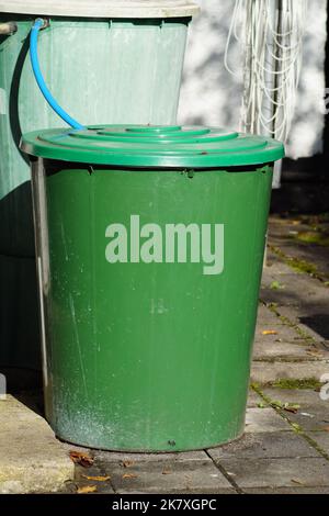 Green rainwater barrel at the house Stock Photo