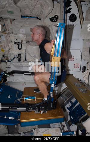 NASA astronaut Steve Swanson, Expedition 39 flight engineer, works out on the Advanced Resistive Exercise Device (ARED) aboard the Earth-orbiting International Space Station on April 11, 2014 Stock Photo