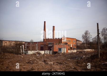 Brick factory. The old factory. Industrial landscape. Brick pipes. Industrial processing area. Environmental pollution. Entirely red building. Stock Photo