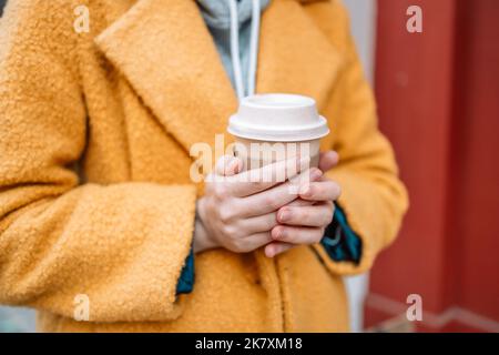 Woman female hand with coffee cup paper latte. Cup in a holder, coffee cup to go takeaway  Stock Photo