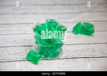 Dishwashing Tablets in Glass Container on white wood counter Stock Photo