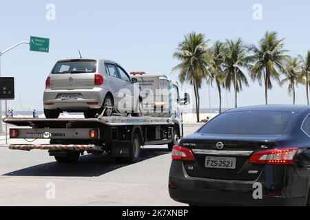 Tow truck towing impounded vehicles for traffic violations. Illegal parking, punishment and fine for irregular driving Stock Photo