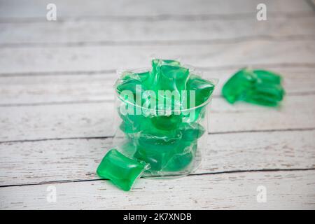 Dishwashing Tablets in Glass Container on white wood counter Stock Photo