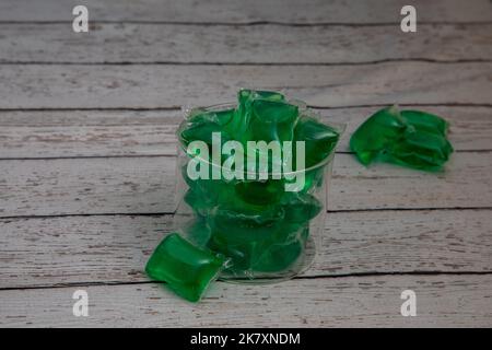 Dishwashing Tablets in Glass Container on white wood counter Stock Photo