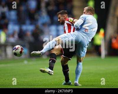 Coventry, UK. 19th Oct, 2022. Jake Bidwell of Coventry City tackles George Baldock of Sheffield Utd during the Sky Bet Championship match at the Coventry Building Society Arena, Coventry. Picture credit should read: Darren Staples/Sportimage Credit: Sportimage/Alamy Live News Stock Photo