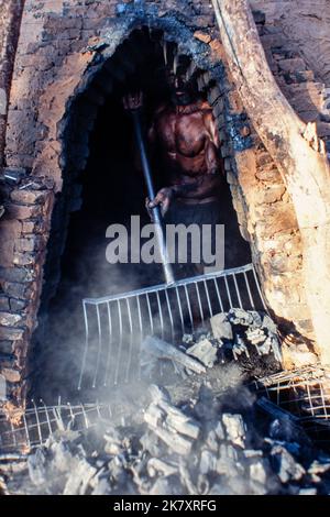 Production of vegetal charcoal to be used as fuel to produce pig iron - the intermediate product of smelting iron ore – increases Cerrado biome deforestation - Mato Grosso do Sul State, Mid-west Brazil. Modern steel mills and direct-reduction iron plants transfer the molten iron to a ladle for immediate use in the steel making furnaces. Stock Photo