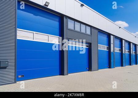 industrial unit with blue shutter doors Stock Photo