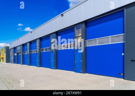 industrial unit with blue shutter doors Stock Photo