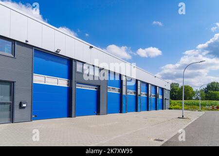 industrial unit with blue shutter doors Stock Photo