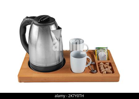 Group of coffee making set in a hotel room with stainless steel electric kettle, clean cup, teaspoon. Tea and coffee cup set in hotel room, ceramic cu Stock Photo