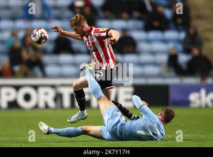 Coventry, UK. 19th Oct, 2022. Tommy Doyle of Sheffield Utd tackled by Jake Bidwell of Coventry City during the Sky Bet Championship match at the Coventry Building Society Arena, Coventry. Picture credit should read: Darren Staples/Sportimage Credit: Sportimage/Alamy Live News Stock Photo