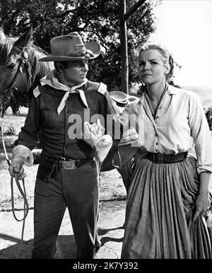 Audie Murphy & Laraine Stephens Film: 40 Guns To Apache Pass (1964) Characters: Capt. Bruce Coburn, Ellen Malone  Director: William Witney 01 May 1967   **WARNING** This Photograph is for editorial use only and is the copyright of COLUMBIA and/or the Photographer assigned by the Film or Production Company and can only be reproduced by publications in conjunction with the promotion of the above Film. A Mandatory Credit To COLUMBIA is required. The Photographer should also be credited when known. No commercial use can be granted without written authority from the Film Company. Stock Photo