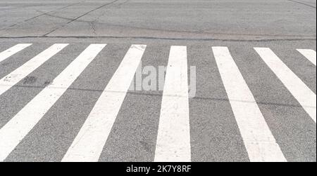 The classic white crosswalk stripes are a bit like piano keys Stock Photo