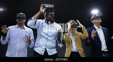 People using virtual reality headset and gesturing Stock Photo