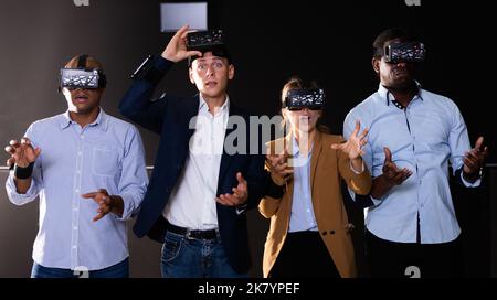 People using virtual reality headset and gesturing Stock Photo
