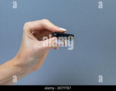 USB Type C adapter or hub with various accessories - pendrives, hdmi, ethernet, memory card, cables. Hands holding various converter cables for comput Stock Photo