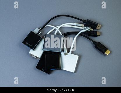 USB Type C adapter or hub with various accessories - pendrives, hdmi, ethernet, memory card, cables. Hands holding various converter cables for comput Stock Photo