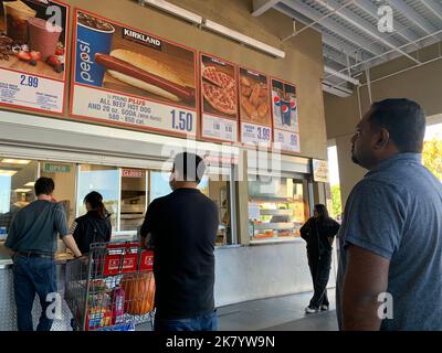 Beijing, Hebei, China. 15th Oct, 2022. Customers wait in line to order below signage for the Costco Kirkland Signature $1.50 hot dog and soda combo, which has maintained the same price since 1985 despite consumer price increases and inflation, at the food court outside a Costco Wholesale Corp. store in San Jose, California. (Credit Image: © David G. McIntyre/ZUMA Press Wire) Stock Photo