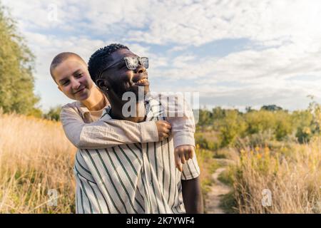 Naturally beautiful outdoor portrait of two ethnically different close friends or lovers spending their time in countryside. Traveling and leisure time. High quality photo Stock Photo