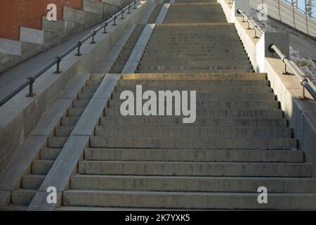 Long staircase up. Architecture details. Steps and ramp for lifting stroller. Stock Photo