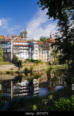 Historic buildings reflected in the Tamega river, Amarante, Portugal. Stock Photo