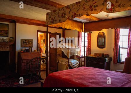 An adult and child poster beads in the bedroom at Cogswell's Grant in Essex, Massachusetts. Stock Photo