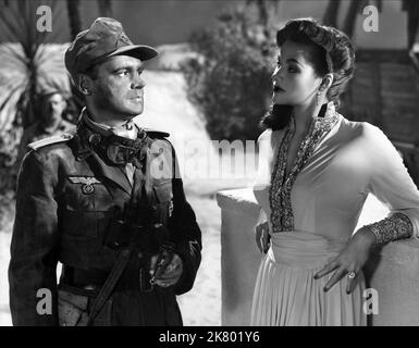 Albert Lieven & Yvonne De Carlo Film: Hotel Sahara (1956) Characters: Lt. Gunther von Heilicke, Yasmin Pallas  Director: Ken Annakin 12 October 1951   **WARNING** This Photograph is for editorial use only and is the copyright of UNITED ARTIST and/or the Photographer assigned by the Film or Production Company and can only be reproduced by publications in conjunction with the promotion of the above Film. A Mandatory Credit To UNITED ARTIST is required. The Photographer should also be credited when known. No commercial use can be granted without written authority from the Film Company. Stock Photo