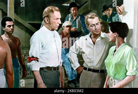 Lloyd Nolan, Alan Ladd & Rossana Podesta Film: The Gun Runner; Santiago (1957) Characters: Clay Pike,Caleb 'Cash' Adams &  Director: Gordon Douglas 13 July 1956   **WARNING** This Photograph is for editorial use only and is the copyright of WARNER BROS and/or the Photographer assigned by the Film or Production Company and can only be reproduced by publications in conjunction with the promotion of the above Film. A Mandatory Credit To WARNER BROS is required. The Photographer should also be credited when known. No commercial use can be granted without written authority from the Film Company. Stock Photo