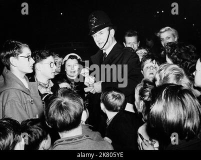 Jack Warner With Fans Television: Dixon Of Dock Green (1959) Characters: PC George Dixon WITH  12 January 1957   **WARNING** This Photograph is for editorial use only and is the copyright of BBC and/or the Photographer assigned by the Film or Production Company and can only be reproduced by publications in conjunction with the promotion of the above Film. A Mandatory Credit To BBC is required. The Photographer should also be credited when known. No commercial use can be granted without written authority from the Film Company. Stock Photo