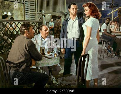Robert Mitchum, Bernard Lee, Jack Lemmon, Rita Hayworth Film: Fire Down Below (1955) Characters: Felix Bowers,Dr. Sam Blake,Tony,Irena  Director: Robert Parrish 08 August 1957   **WARNING** This Photograph is for editorial use only and is the copyright of COLUMBIA and/or the Photographer assigned by the Film or Production Company and can only be reproduced by publications in conjunction with the promotion of the above Film. A Mandatory Credit To COLUMBIA is required. The Photographer should also be credited when known. No commercial use can be granted without written authority from the Film Co Stock Photo