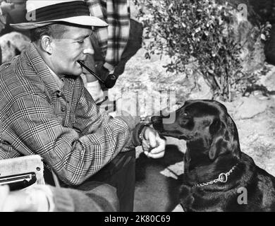 Bing Crosby & Dog Film: Just For You (1954) Characters: Jordan Blake  Director: Elliott Nugent 01 September 1952   **WARNING** This Photograph is for editorial use only and is the copyright of PARAMOUNT and/or the Photographer assigned by the Film or Production Company and can only be reproduced by publications in conjunction with the promotion of the above Film. A Mandatory Credit To PARAMOUNT is required. The Photographer should also be credited when known. No commercial use can be granted without written authority from the Film Company. Stock Photo