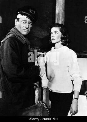 John Wayne & Lauren Bacall Film: Blood Alley (USA 1955) Characters: Capt. Tom Wilder, Cathy Grainger  Director: William A. Wellman 01 October 1955   **WARNING** This Photograph is for editorial use only and is the copyright of WARNER and/or the Photographer assigned by the Film or Production Company and can only be reproduced by publications in conjunction with the promotion of the above Film. A Mandatory Credit To WARNER is required. The Photographer should also be credited when known. No commercial use can be granted without written authority from the Film Company. Stock Photo