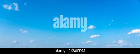 Blue panoramic sky background with small white clouds Stock Photo