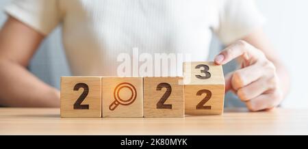 2022 change to 2023 block with magnifying glass icon. SEO, Search Engine Optimization, hiring , Advertising, Idea, Strategy, marketing, Keyword, Conte Stock Photo