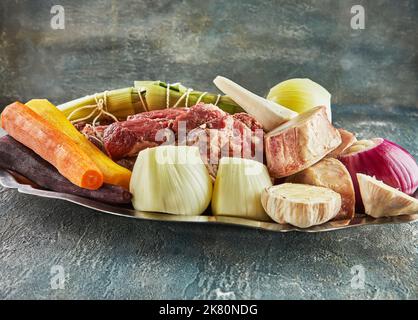 Piece of fresh beef with carrots, onions and garlic Stock Photo