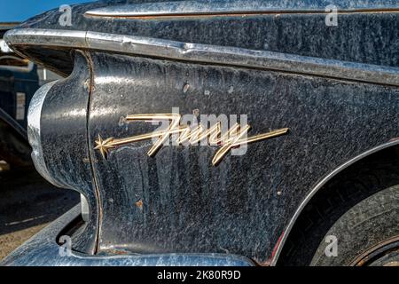 The chrome logo on the front driver side of a black 1960 Plymouth Fury in Wells, Nevada, USA Stock Photo