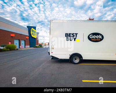 New Hartford, New York - Oct 1, 2022: Landscape Wide View of Geek Squad White Truck in foreground and Best Buy Building in Background. Stock Photo