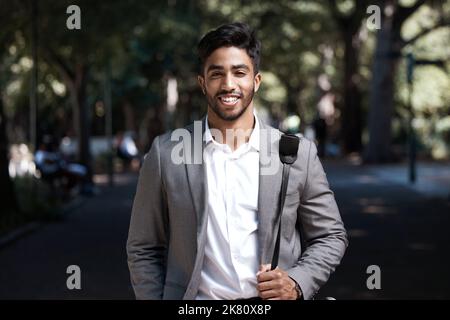 Smiling makes any day better. a young businessman standing in the city. Stock Photo