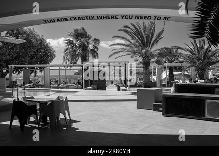 Ios, Greece - September 6, 2022 : View of the very popular Far out beach bar and the sea in the background in Ios Greece in black and white Stock Photo