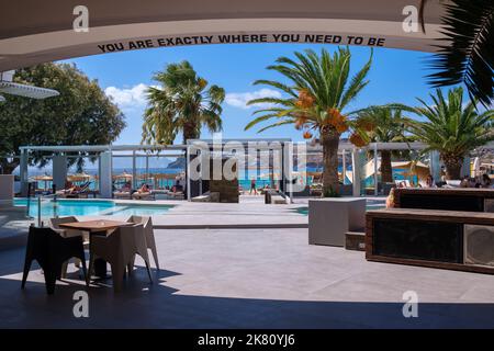 Ios, Greece - September 6, 2022 : View of the very popular Far out beach bar and the sea in the background in Ios Greece Stock Photo