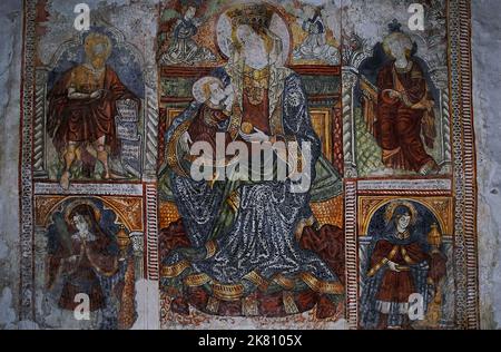 Damaged but vibrant late-1400s fresco painted and signed by German artist, Albert of Konstanz, in the Church of the Blessed Virgin and Saint George the Younger at Plomin, Istria, Croatia.  Saints including John the Baptist and early Christian martyr brothers Cosmas and Damian surround a central Virgin Mary holding an apple as she suckles the baby Jesus. Stock Photo