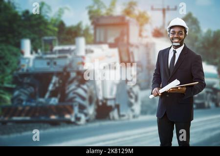 African Engineer Architecture Manager holding a tablet for working on the road construction site and   inspection project road construction developmen Stock Photo