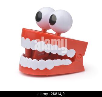 Funny toy clockwork jumping teeth with eyes isolated on white Stock Photo