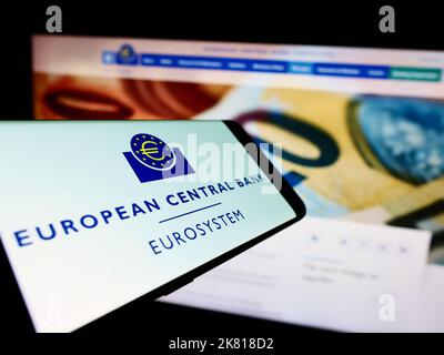 Mobile phone with logo of EU institution European Central Bank (ECB) on screen in front of website. Focus on center-right of phone display. Stock Photo