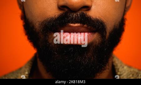 close up of cropped and bearded african american man isolated on orange,stock image Stock Photo