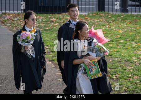 An Asian graduate from Imperial College London holds a Lego aircraft model while celebrating her education success with friends and families after their graduation ceremony at the Royal Albert Hall, on 19th October 2022, in London, England. Stock Photo