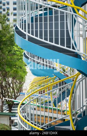 A vertical shot of Spiral stairwell in old Singapore apartment blocks Stock Photo