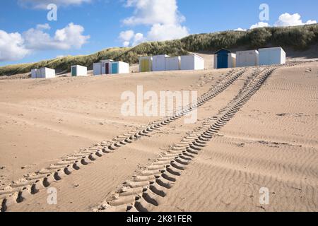 beach cabins and tire track on the beach in Oostkapelle on the peninsula Walcheren, Zeeland, Netherlands. Strandhaeuschen und Reifenspur am Strand von Stock Photo